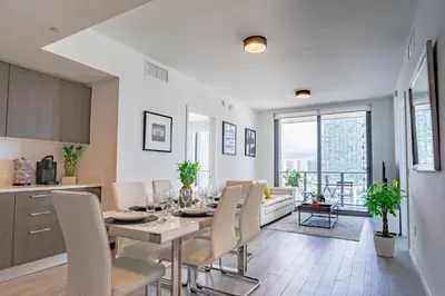 a kitchen and dining room with a table and chairs at Luxurious 2-Bed Apartment with Breathtaking Bay views!! in Miami