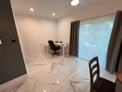 a room with a desk and a chair and a window at Luxe Fort Lauderdale in Fort Lauderdale