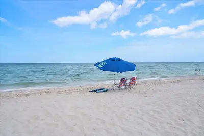 two chairs and an umbrella on the beach at Walnut By The Sea in Hollywood