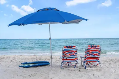 two chairs and an umbrella on the beach at Walnut By The Sea in Hollywood