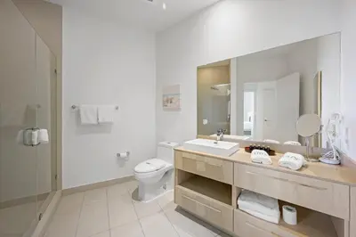 a bathroom with a sink and a toilet and a mirror at Beautiful Beachfront Penthouse in Hollywood