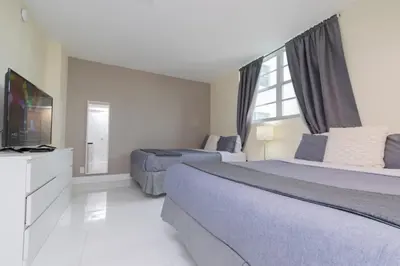 a hotel room with two beds and a television at The Tides apartment Go Holiday Home 5th floor in Hollywood