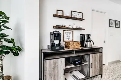 a living room with a table with a coffee maker on it at *Victoria Park Pool Home- close to beach/Las Olas* in Fort Lauderdale