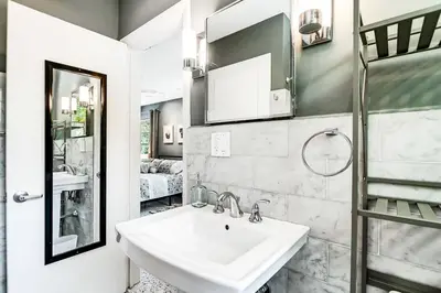 a bathroom with a sink and a mirror at *Victoria Park Pool Home- close to beach/Las Olas* in Fort Lauderdale