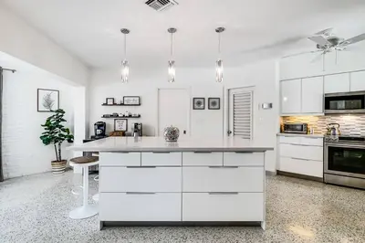 a kitchen with white cabinets and a white counter top at *Victoria Park Pool Home- close to beach/Las Olas* in Fort Lauderdale