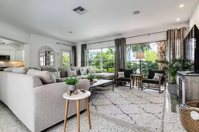 a living room with a couch and a table at *Victoria Park Pool Home- close to beach/Las Olas* in Fort Lauderdale