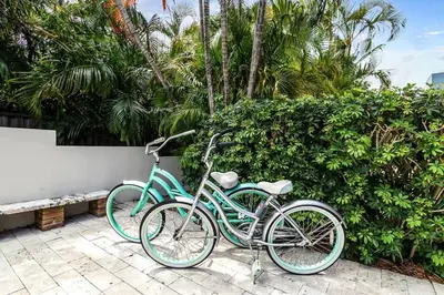 two bikes are parked next to a wall at *Victoria Park Pool Home- close to beach/Las Olas* in Fort Lauderdale