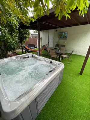a large hot tub in a yard with green grass at “La Casita” Beautiful home in the heart of Miami ! in Miami