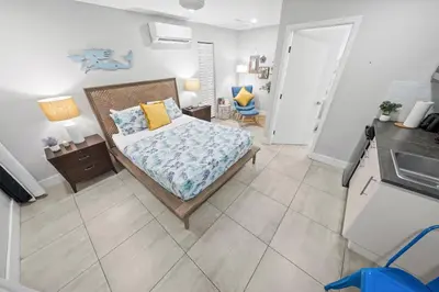 a small bedroom with a bed and a kitchen at Casa Cordova Apartments By Lowkl in Fort Lauderdale