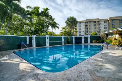 a large blue swimming pool in a building at Casa Cordova Apartments By Lowkl in Fort Lauderdale