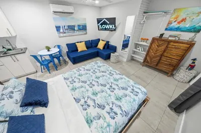 a living room with a blue couch and a table at Casa Cordova Apartments By Lowkl in Fort Lauderdale