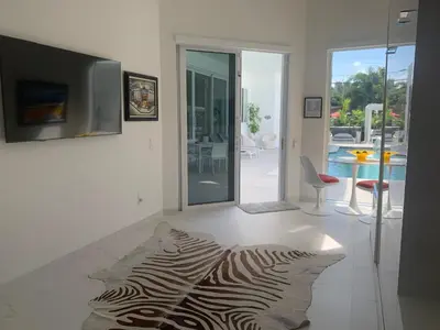 a living room with a zebra rug on the floor at Men only clothing option guesthouse near Wilton Manors in Fort Lauderdale