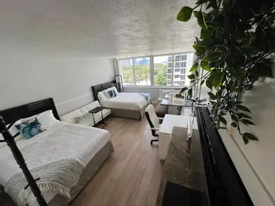 a bedroom with a bed and a couch and a table at Lovely beaches ocean & city view in Miami Beach