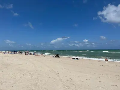 a group of people on a beach near the ocean at Lovely beaches ocean & city view in Miami Beach