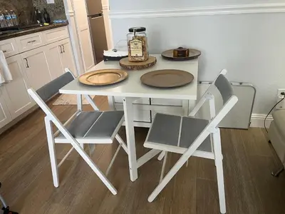 a white table with two chairs and a bottle on it at Lovely beaches ocean & city view in Miami Beach