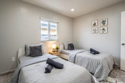 a bedroom with two beds and a window at Renovated 2 BD Home w/ Private Parking, Gallery & W/D in Miami