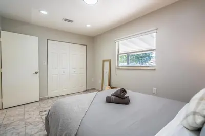 a bedroom with a bed with a stuffed animal on it at Renovated 2 BD Home w/ Private Parking, Gallery & W/D in Miami