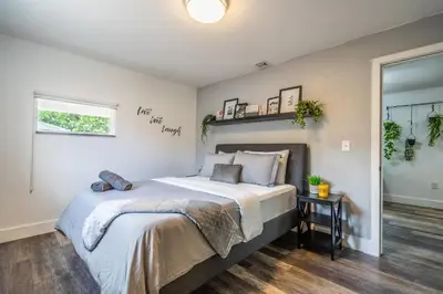 a bedroom with a large bed and a window at 2 BD Home w/ Private Parking, Private Yard & W/D in Miami