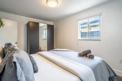 a bedroom with a large white bed with a window at 2 BD Home w/ Private Parking, Private Yard & W/D in Miami