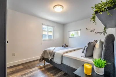 a bedroom with a bed and a table at 2 BD Home w/ Private Parking, Private Yard & W/D in Miami
