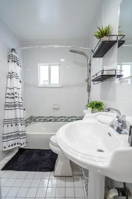 a bathroom with a sink and a toilet and a tub at 2 BD Home w/ Private Parking, Private Yard & W/D in Miami
