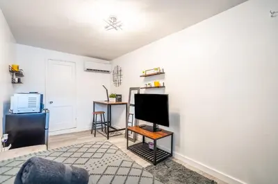 a living room with a flat screen tv on a wall at Cozy Studio w/gated parking in Miami