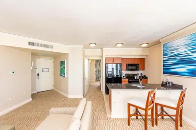 a living room and kitchen with a couch and chairs at TRUMP INTERNATIONAL BEACH RESORT 2 BEDROOM APARTMENT 1600 Sf Ocean and Bay View With Terrace in Miami Beach