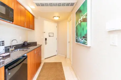 a small kitchen with a sink and a microwave at TRUMP INTERNATIONAL BEACH RESORT 2 BEDROOM APARTMENT 1600 Sf Ocean and Bay View With Terrace in Miami Beach