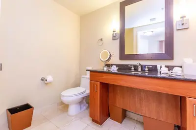 a bathroom with a sink and a toilet and a mirror at TRUMP INTERNATIONAL BEACH RESORT 2 BEDROOM APARTMENT 1600 Sf Ocean and Bay View With Terrace in Miami Beach