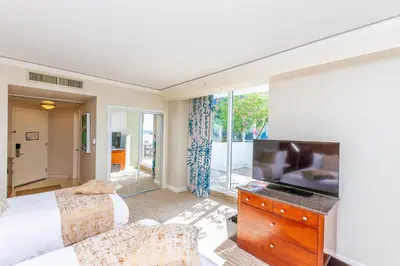 a bedroom with a bed and a flat screen tv at TRUMP INTERNATIONAL BEACH RESORT 2 BEDROOM APARTMENT 1600 Sf Ocean and Bay View With Terrace in Miami Beach