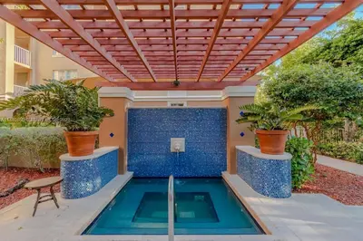 a swimming pool in a house with a pergola at Spacious 3 Bedroom Condo in Aventura in Aventura