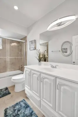 a white bathroom with a sink and a toilet at By Hard Rock Guitar Hotel casino 7 min walk in Dania Beach