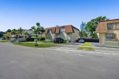 a street in a residential neighborhood with houses at By Hard Rock Guitar Hotel casino 7 min walk in Dania Beach