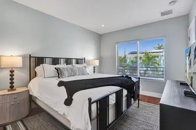 a bedroom with a large bed and a window at Victoria Park Overlook in Fort Lauderdale