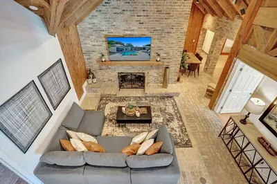 an overhead view of a living room with a couch and a fireplace at Family villa w heated pool gameroom fire pit in Davie