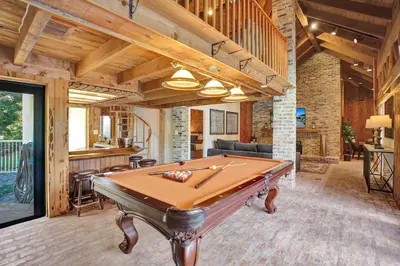 a pool table in the middle of a room at Family villa w heated pool gameroom fire pit in Davie