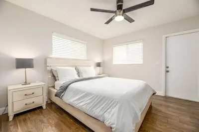 a bedroom with a bed and a ceiling fan at The Guesthouse 1 - Wilton Manors in Fort Lauderdale