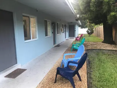 a group of chairs sitting outside of a building at The Guesthouse 1 - Wilton Manors in Fort Lauderdale