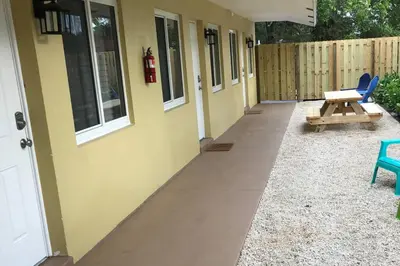 a patio with a bench and a table next to a building at The Retreat 1 - Wilton Manors in Fort Lauderdale
