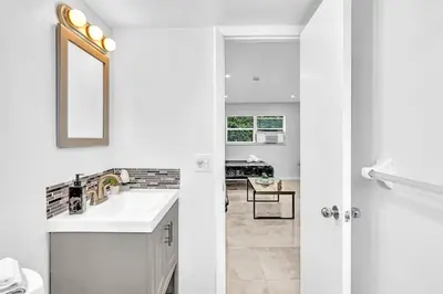 a white bathroom with a sink and a mirror at Hollywood Beach Boutique Vacation Studio LB4 in Hollywood