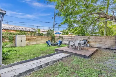 a backyard with a table and chairs and a fence at Two Bedroom Hollywood Beach Vacation Sc01 in Hollywood
