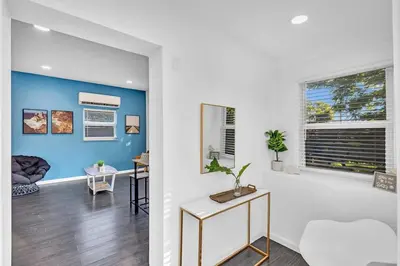 a living room with a blue accent wall at Hollywood 2 Bdrm Beach Vacation & Hard Rock Sc02 in Hollywood