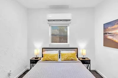 a bedroom with a bed and two night stands at Hollywood 2 Bdrm Beach Vacation & Hard Rock Sc02 in Hollywood