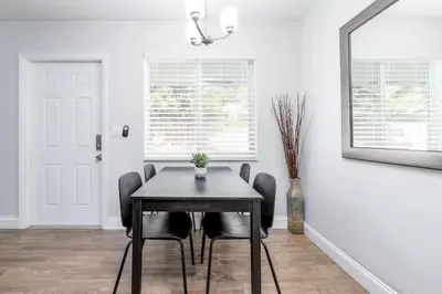a dining room with a black table and chairs at The Guesthouse 2 - Wilton Manors in Fort Lauderdale