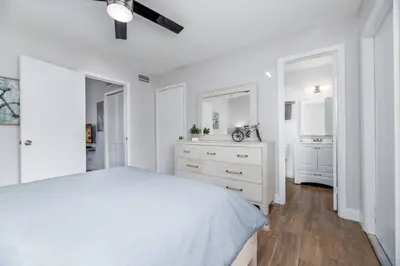 a white bedroom with a bed and a dresser at The Guesthouse 2 - Wilton Manors in Fort Lauderdale