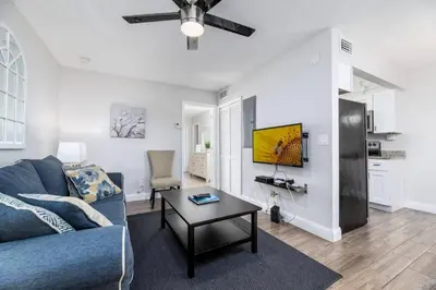 a living room with a blue couch and a table at The Guesthouse 3 - Wilton Manors in Fort Lauderdale