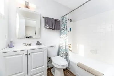 a bathroom with a toilet and a sink and a shower at The Guesthouse 3 - Wilton Manors in Fort Lauderdale