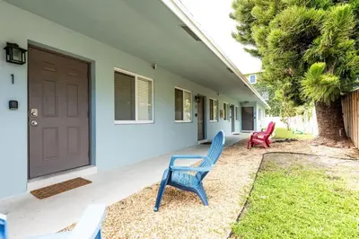two blue chairs sitting outside of a house at The Guesthouse 3 - Wilton Manors in Fort Lauderdale