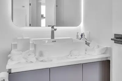 a bathroom with a sink and a mirror and towels at Modern 1 Bed Condo across from Bayside in Downtown in Miami