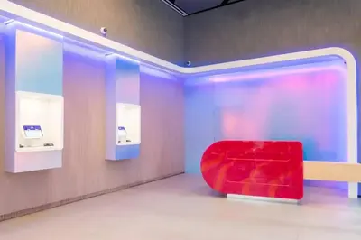 a red chair in a room with a wall at Modern 1 Bed Condo across from Bayside in Downtown in Miami